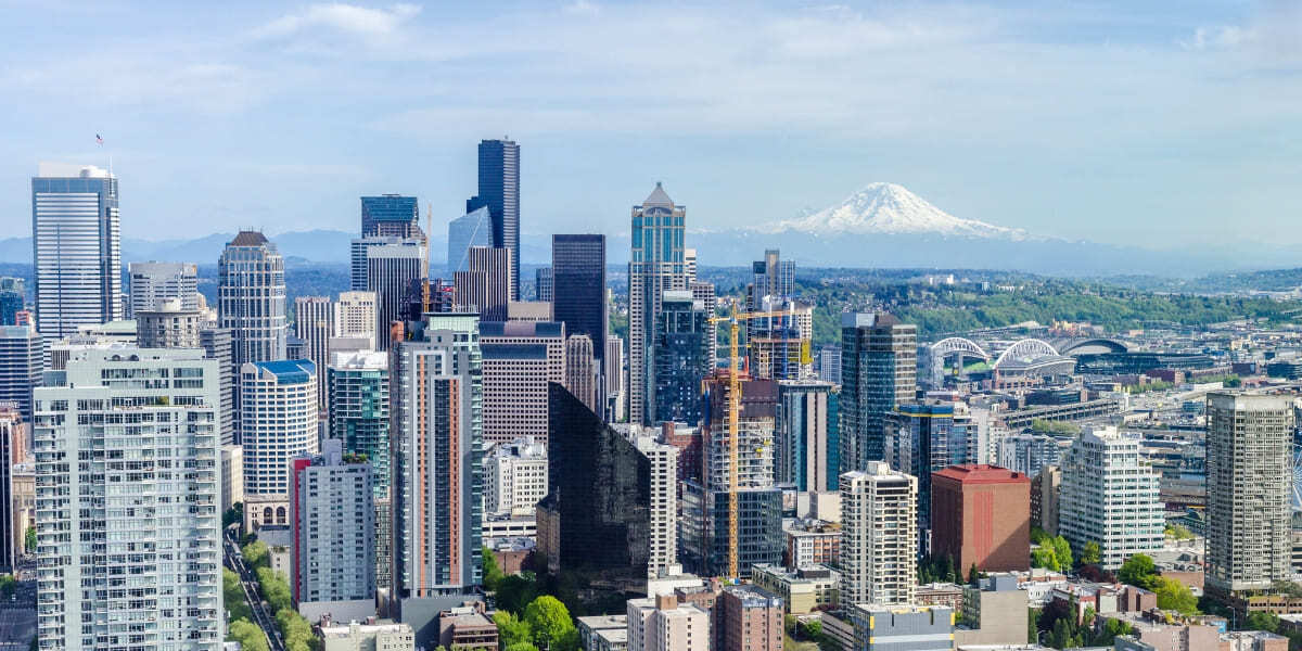 Aerial view of downtown Seattle with Mount Rainier visible in the background on a clear day