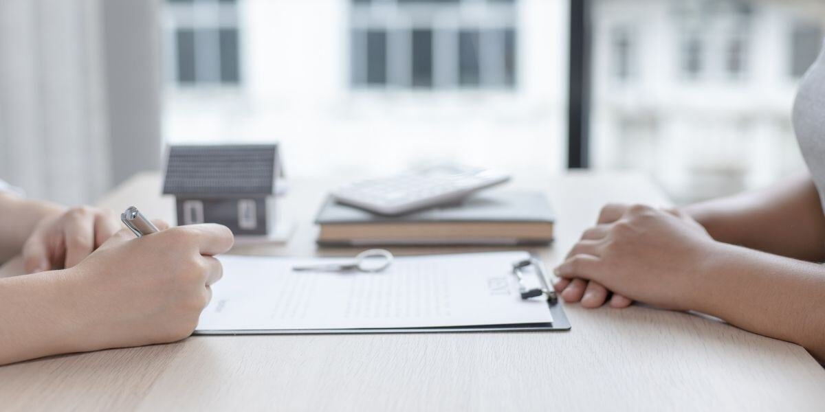 Property manager and potential tenant reviewing a contract 