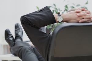 Businessman relaxing after getting positive results from property management